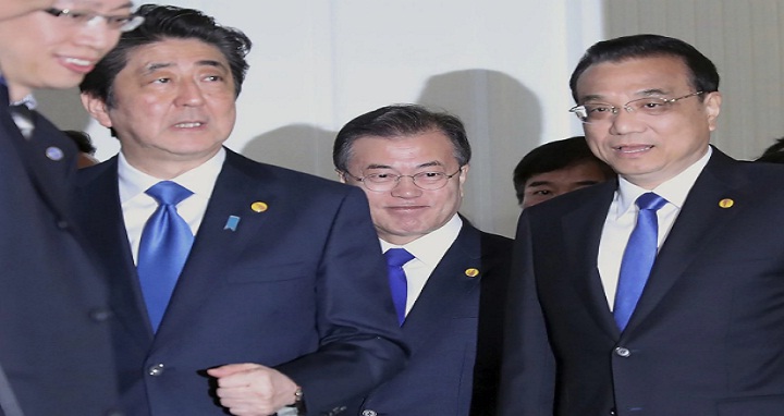 Chinese Premier Li Keqiang, right, Japanese Prime Minister Shinzo Abe, left, and South Korean President Moon Jae-in, center, walk together to their summit venue in Tokyo Wednesday, May 9, 2018. The summit is expected to focus on North Korea’s nuclear program and on improving the sometimes-frayed ties among the three northeast Asian neighbors. (Eugene Hoshiko, Pool/Associated Press)